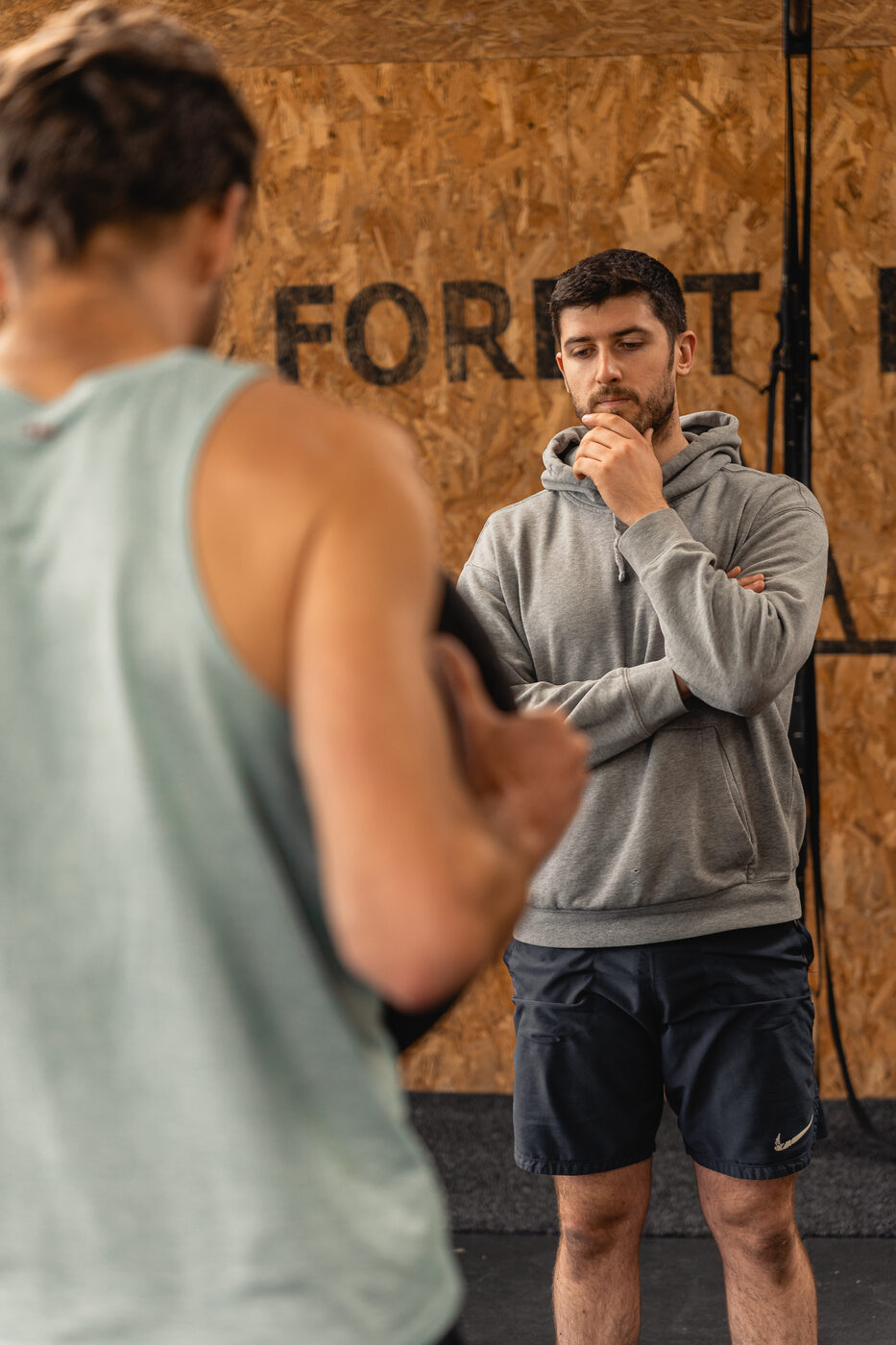 Coach working one-on-one with a client on movement assessment